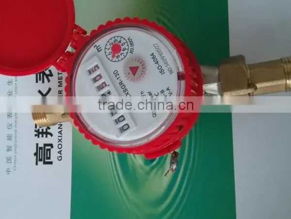 Red mechanical water meter with round dial register